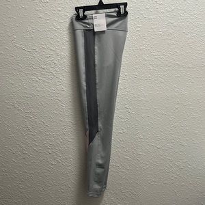NWT- Nike one girl’s tight fit mid rise leggings. Gray/pink. Size Medium